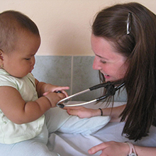 Doctor using a stethoscope on a baby.