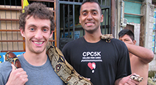 Saul Jacob holding a snake in Ecuador
