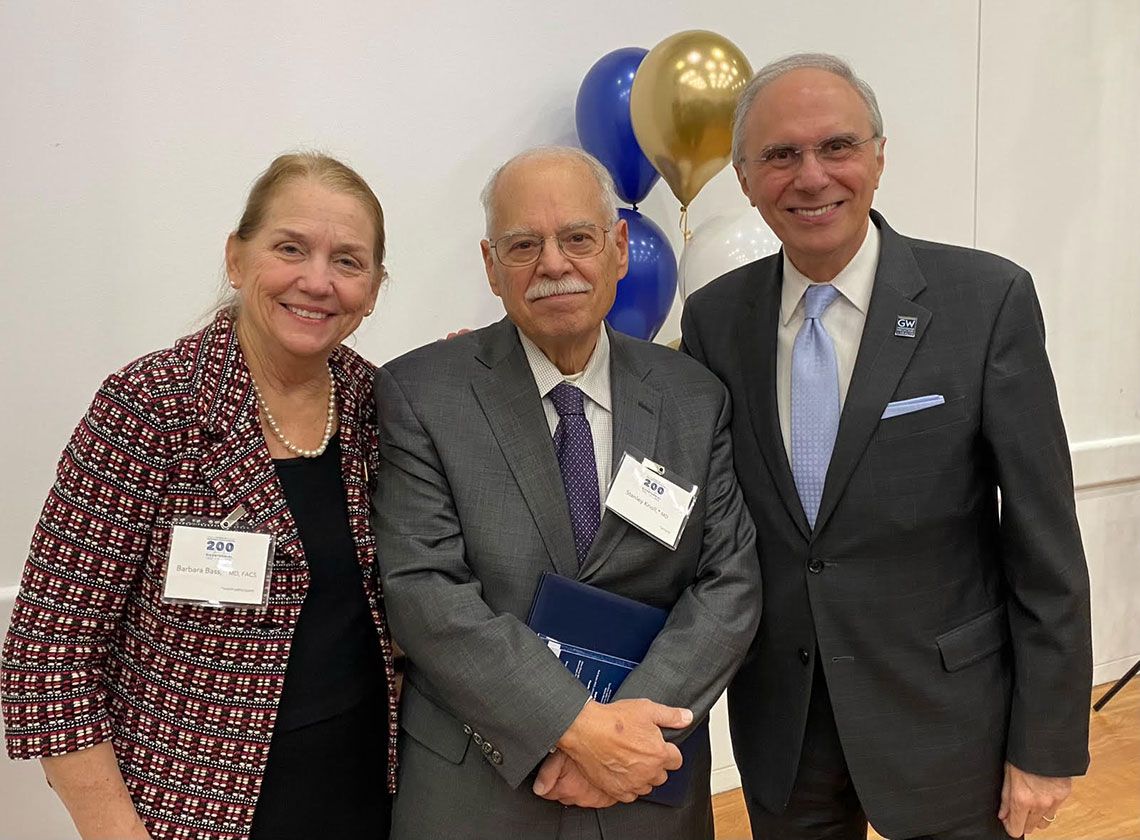 GW SMHS Dean Barbara Bass, Dr. Stanley Knoll, and Dr. Anton Sidawy standing together