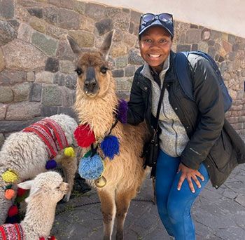 Meredith Wells standing with an Alpaca