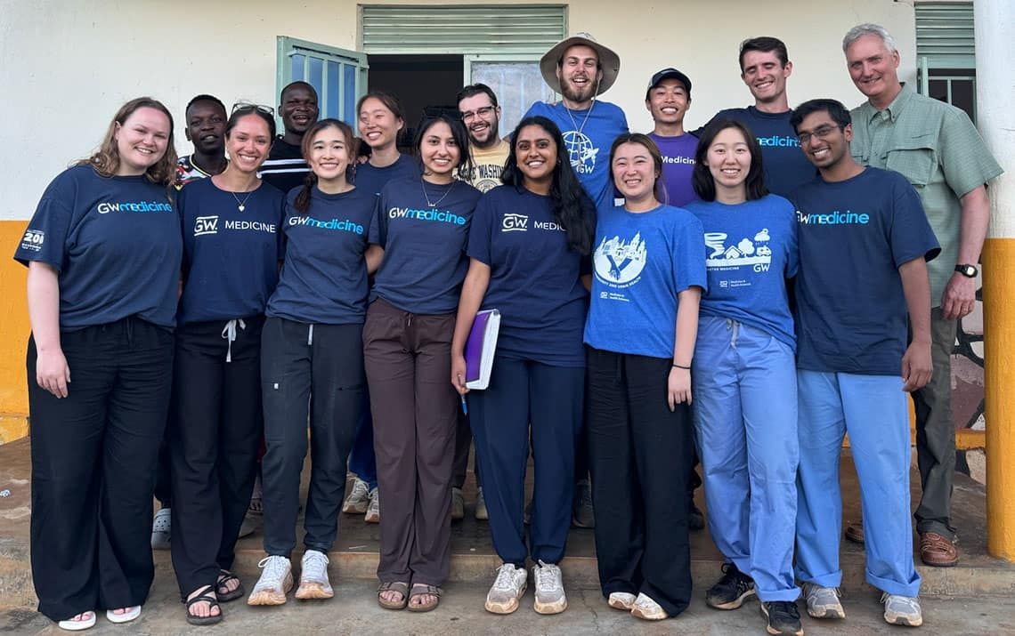 GW medical students standing together in front of the Omni Med office in Makata Village, Uganda