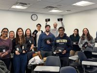 Twelve first-year medical students comprising the Community Health Spring Break Mission to Uganda standing together