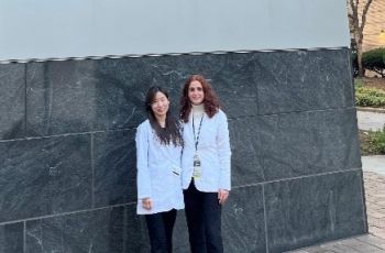 Two doctors standing in front of School of Medicine