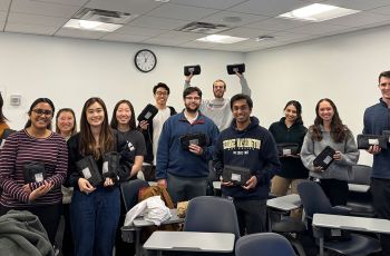 Twelve first-year medical students comprising the Community Health Spring Break Mission to Uganda standing together